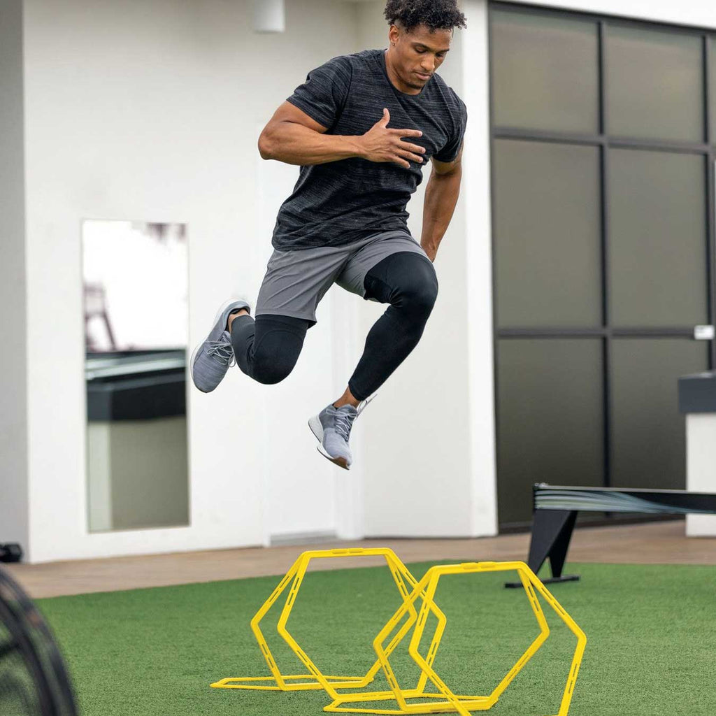 Athlete jumping the SKLZ Speed Web rings set as hurdles