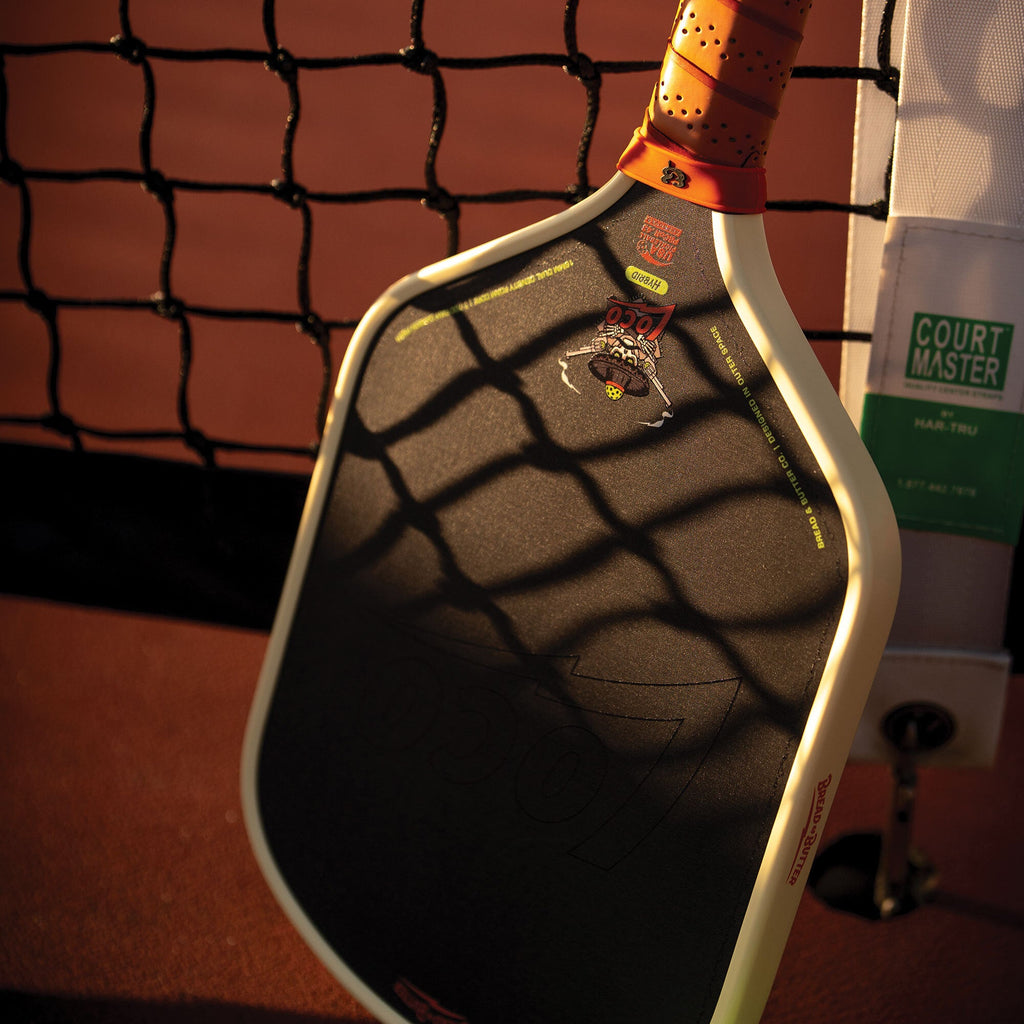 Bread & Butter Loco Hybrid Pickleball Paddle - Cream/Tan, angled view at net