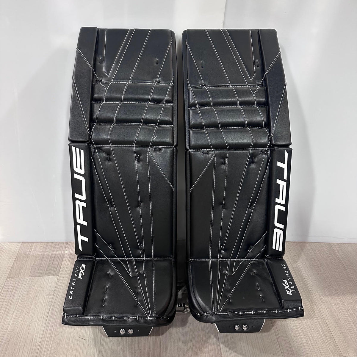 True Catalyst PX3 L87 35+1 Custom Pro Goalie Leg Pads - Black, front view