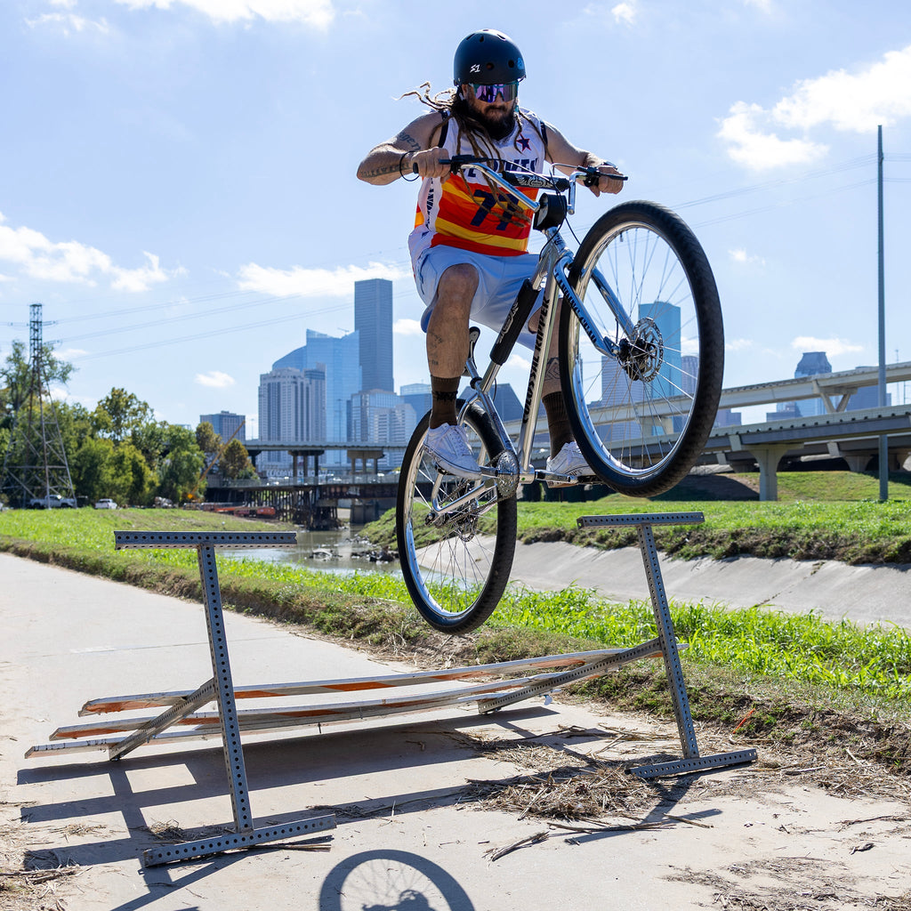 Rider jumping a rail on the SE Colossal Ripper 32
