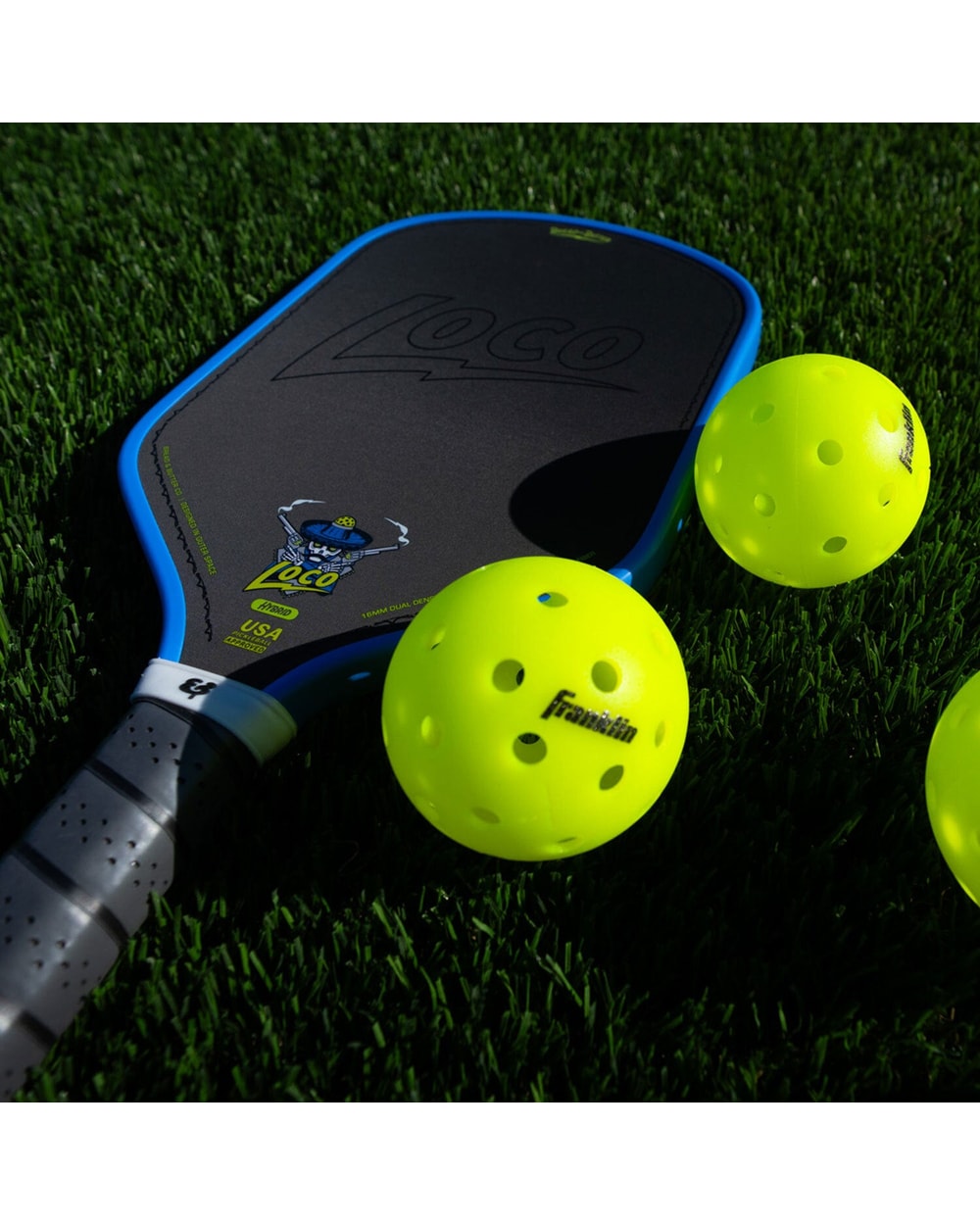 Bread & Butter Loco Hybrid Pickleball Paddle - Blue/Gray, on turf with balls