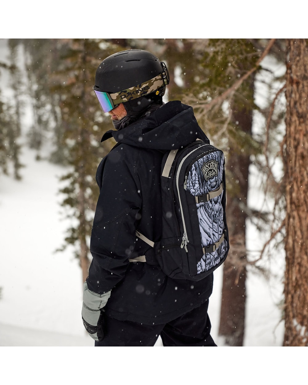 Dakine Mission 25L Backpack X Mayhem - worn on model, side view