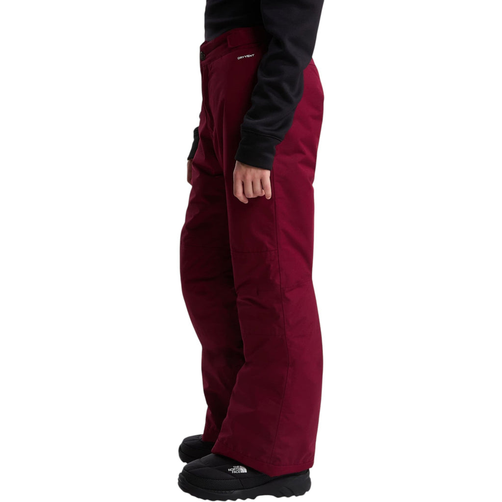 The North Face Girls' Freedom Insulated Pant in Burgundy Crush, side on model